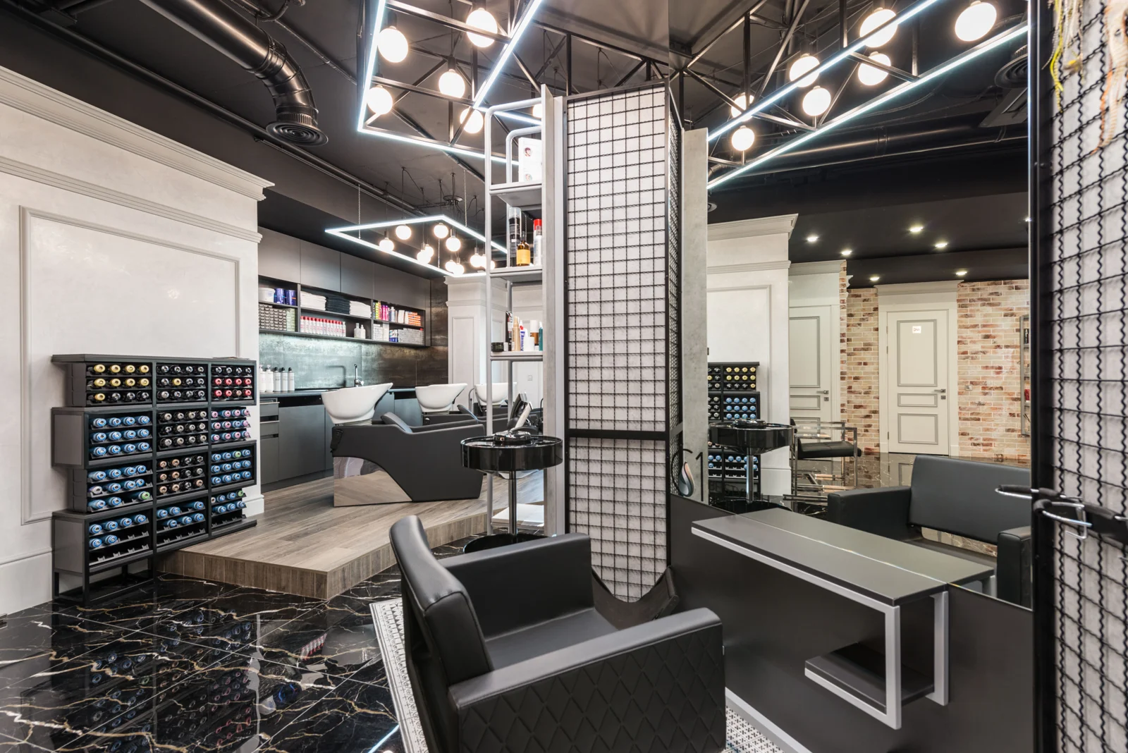 Modern barbershop with black chairs and bright geometric lighting