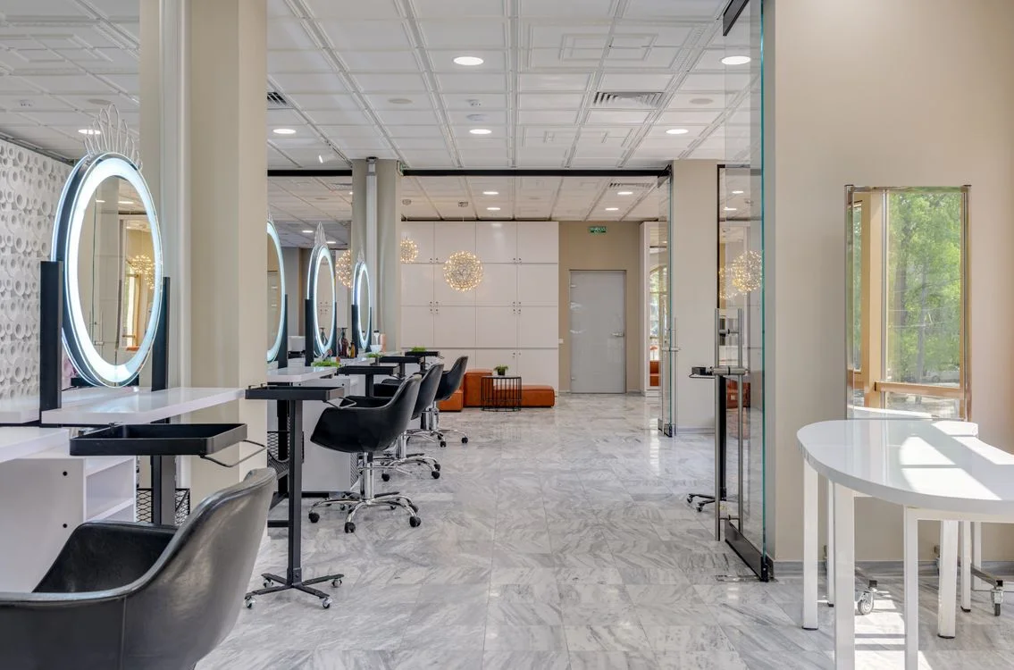 Hair salon with styling chairs and illuminated mirrors