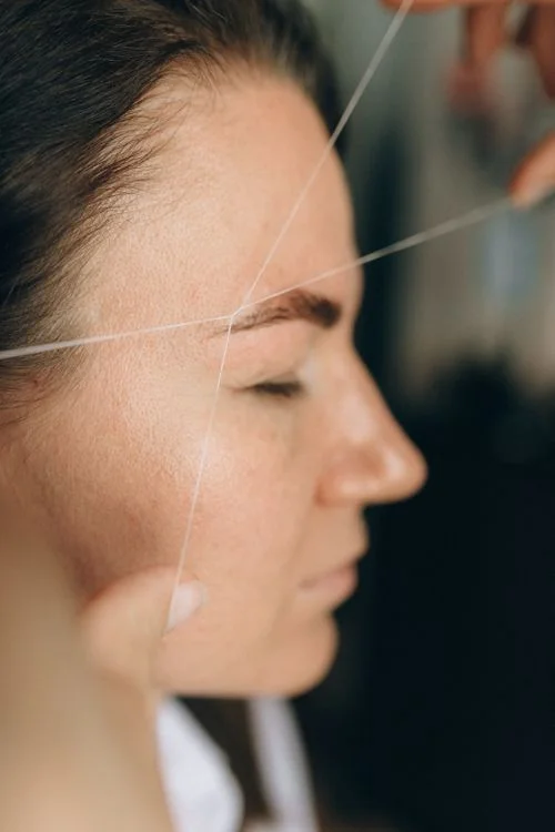Professional eyebrow threading treatment