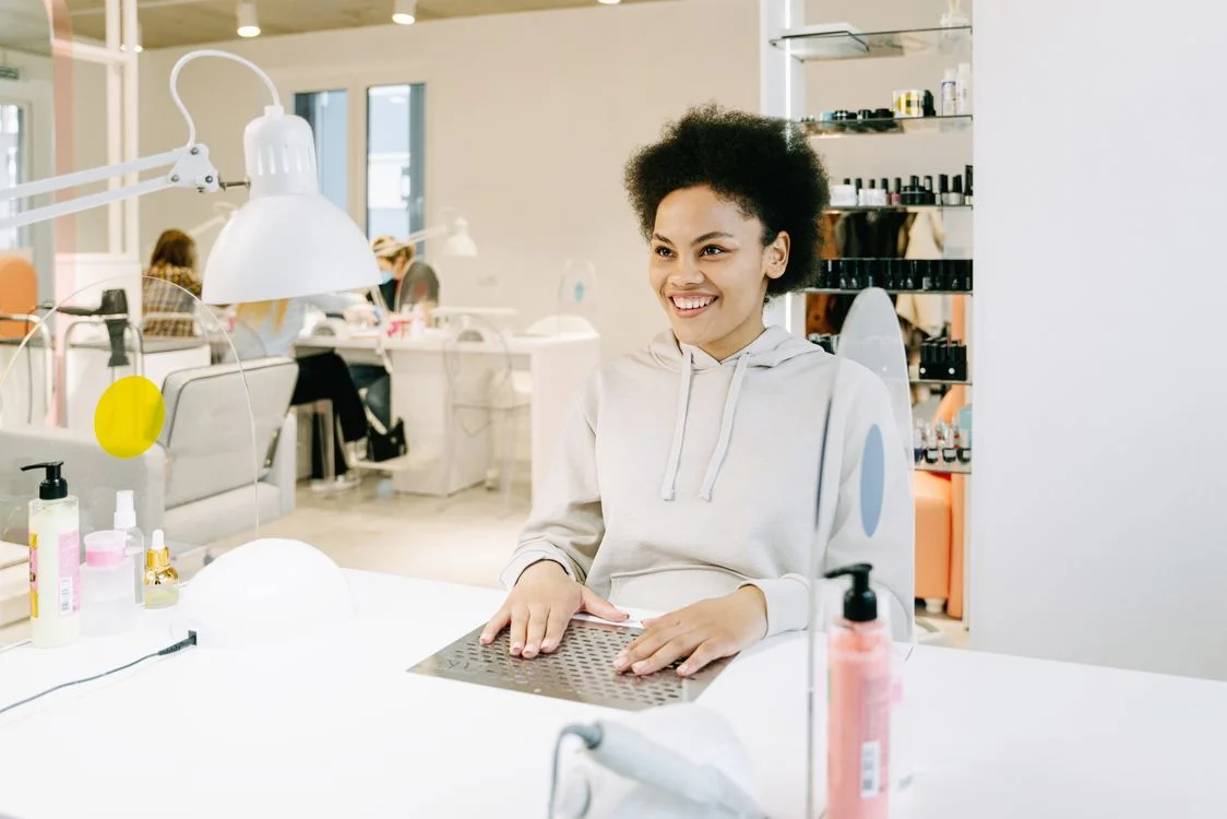 Client at a manicure station in a bright nail salon